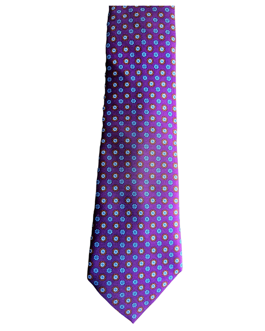 A purple necktie with a repeating pattern of small white and green floral motifs, shown flat against a plain white background.